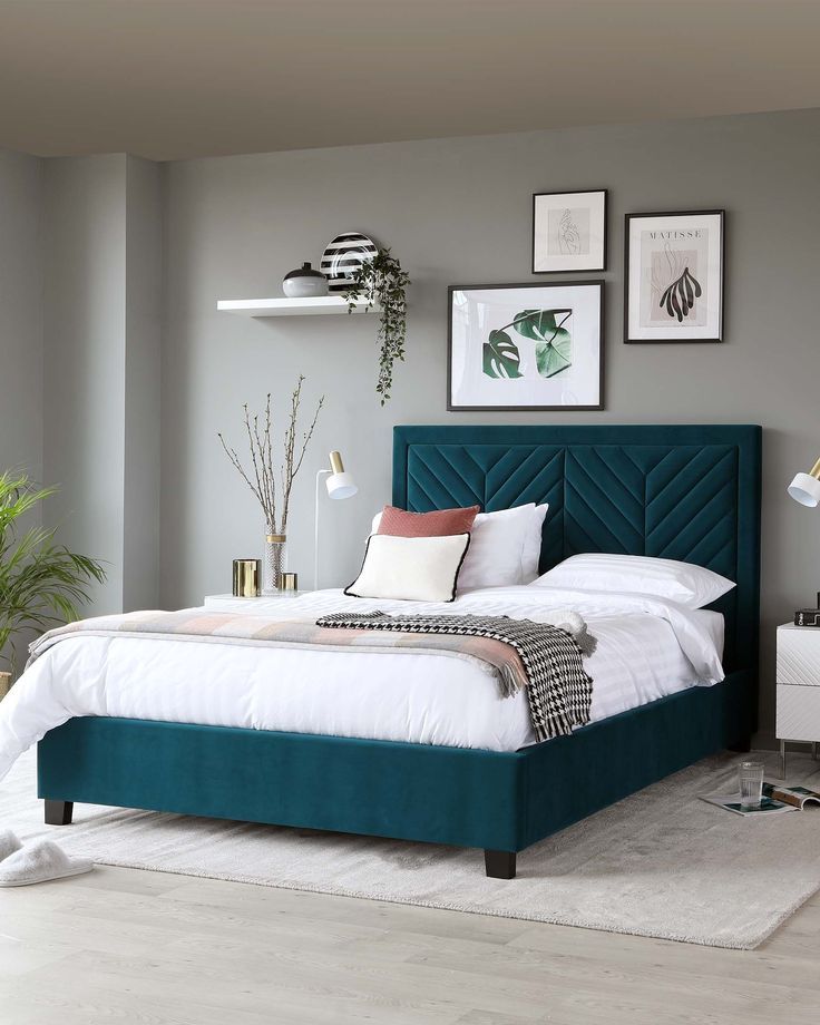 Teal headboard, gray bedding, and white walls