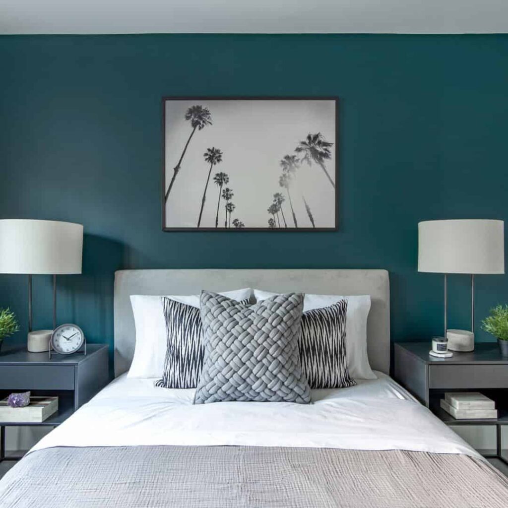 Teal wall, white pillows, and gray frame